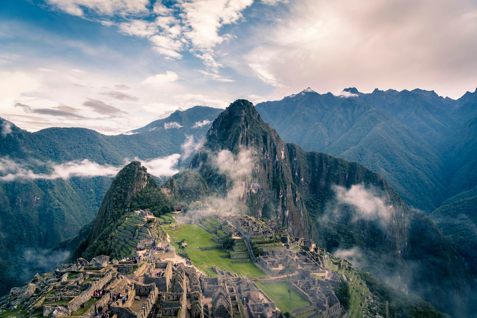 Machu Picchu surrounded by misty green Andean mountains
